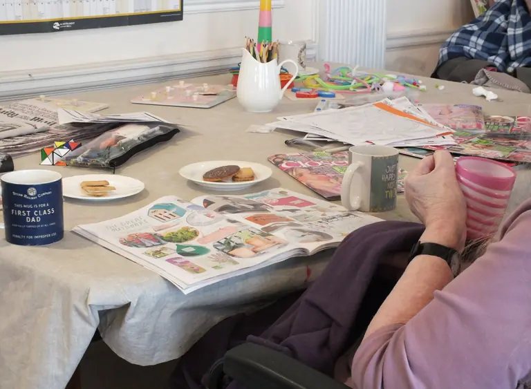 Residents enjoying arts, crafts and conversation around a table
